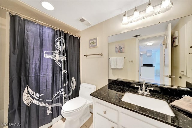 bathroom featuring a shower with shower curtain, tile patterned floors, vanity, and toilet