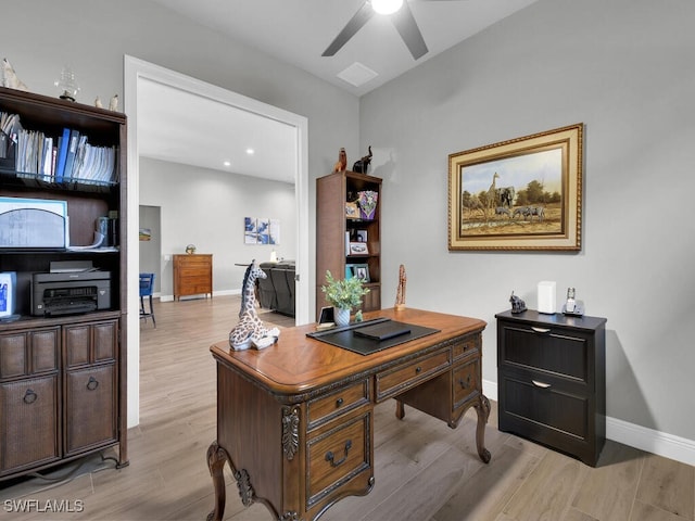 home office with ceiling fan and light hardwood / wood-style floors