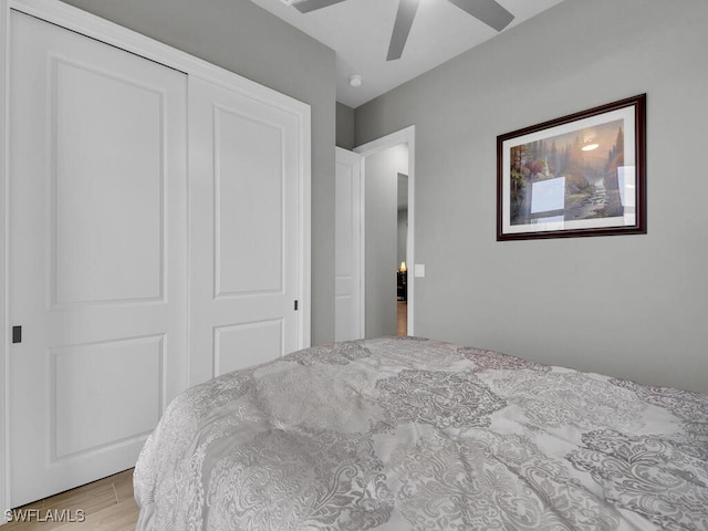 bedroom featuring light hardwood / wood-style flooring, a closet, and ceiling fan