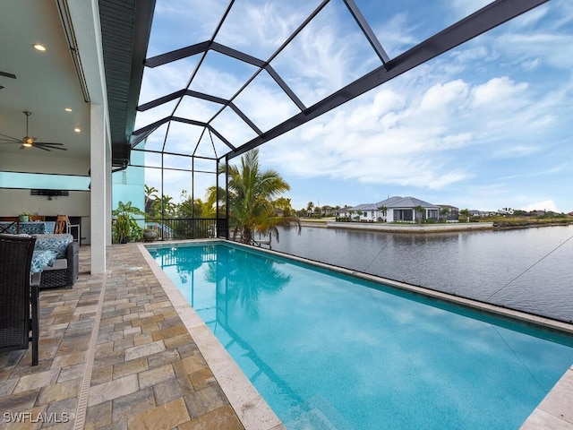 view of pool with a lanai, ceiling fan, a water view, and a patio