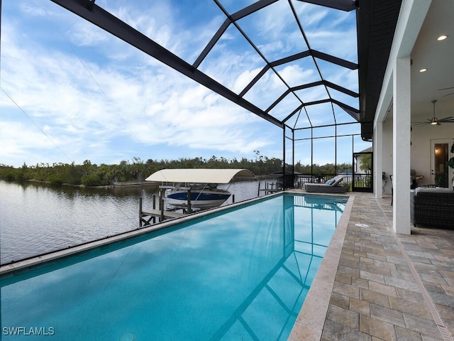 view of swimming pool with a patio, a water view, a dock, and glass enclosure