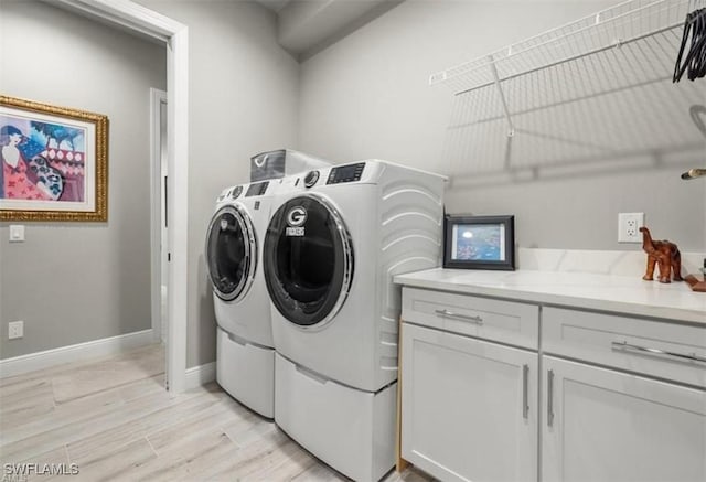 laundry room with light hardwood / wood-style flooring and washer and dryer