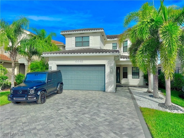 mediterranean / spanish-style house with a garage