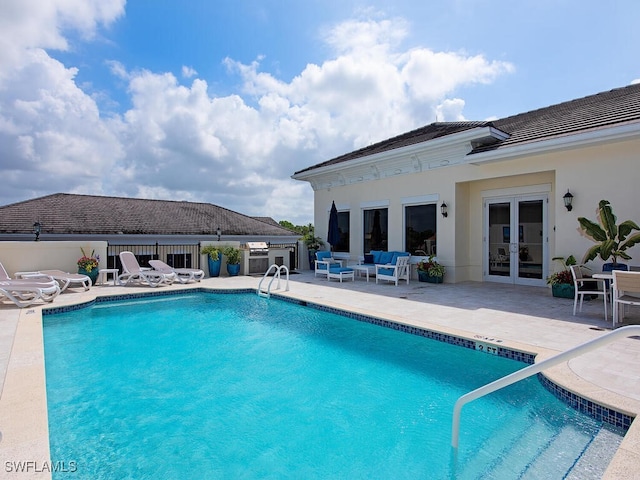 view of pool featuring a patio area, a grill, french doors, and an outdoor hangout area