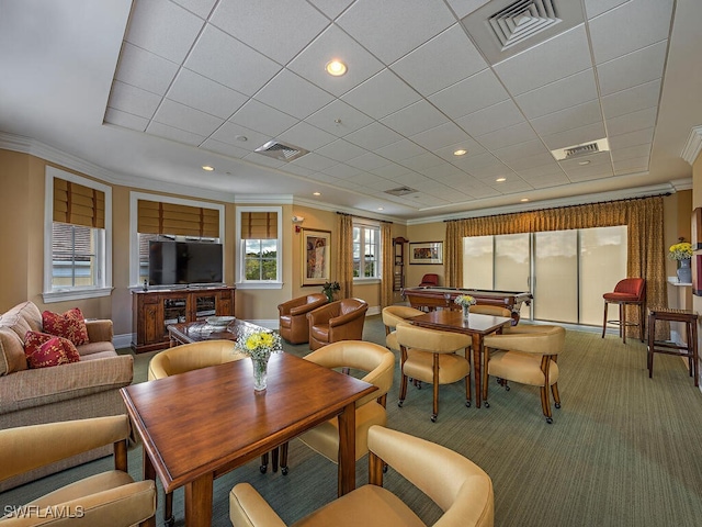 carpeted dining room featuring crown molding