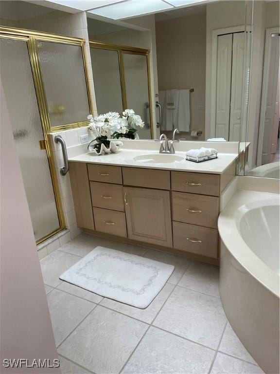 bathroom with tile patterned floors, plus walk in shower, and vanity