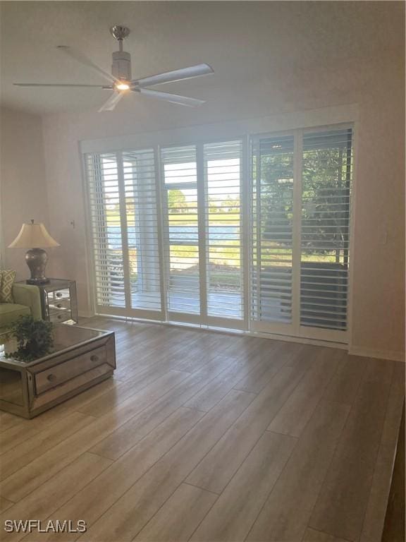 interior space with ceiling fan and light wood-type flooring