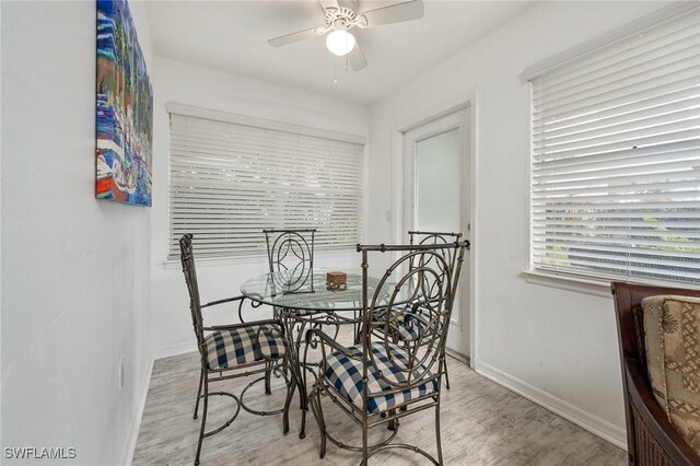 dining area with light hardwood / wood-style floors and ceiling fan