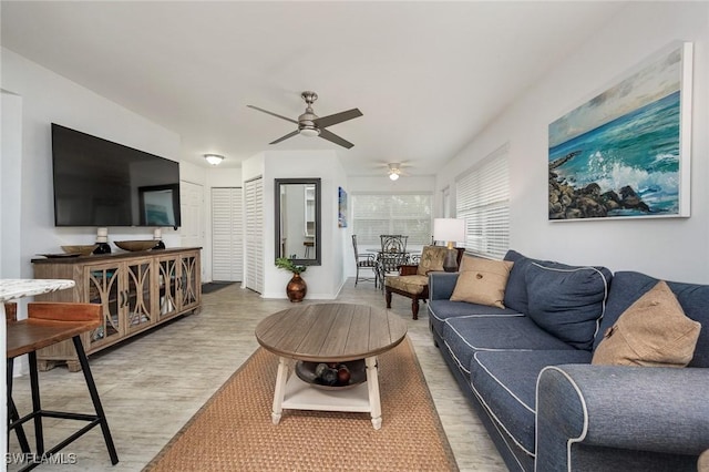 living room with hardwood / wood-style floors and ceiling fan