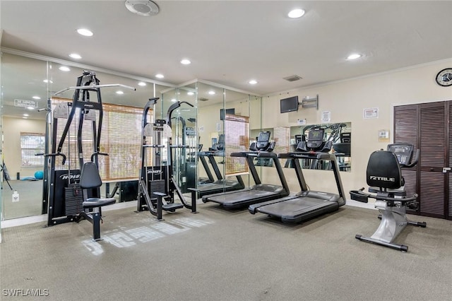 workout area featuring ornamental molding