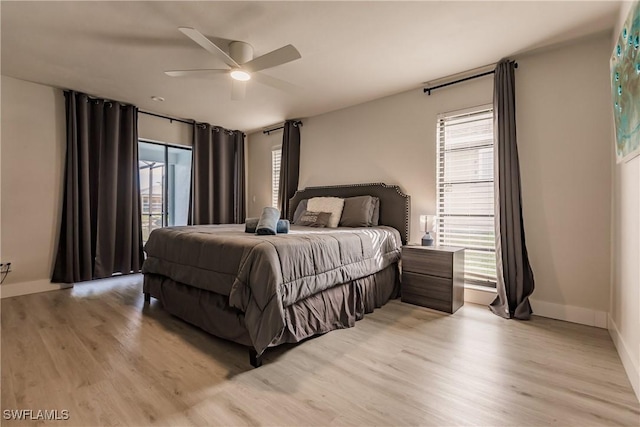 bedroom featuring light wood-type flooring, baseboards, and a ceiling fan