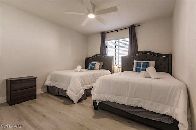 bedroom featuring a ceiling fan and wood finished floors