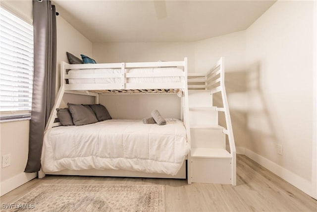 bedroom featuring wood finished floors and baseboards