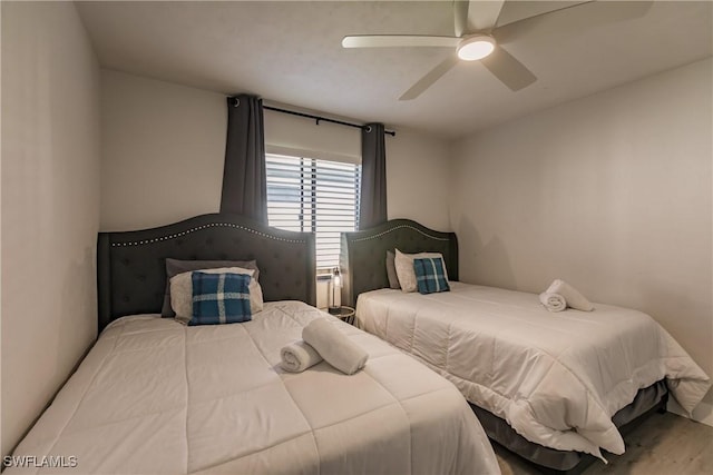 bedroom with a ceiling fan and wood finished floors