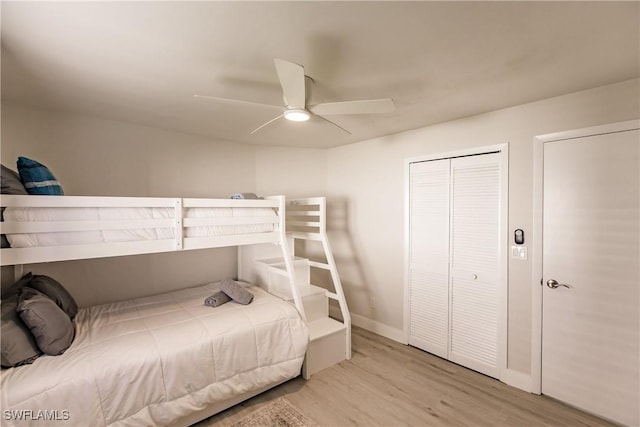 bedroom featuring baseboards, a closet, a ceiling fan, and wood finished floors