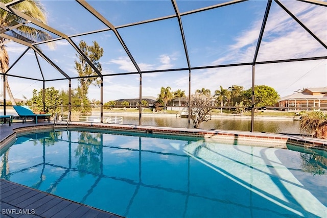 outdoor pool featuring a lanai, a patio area, and a water view