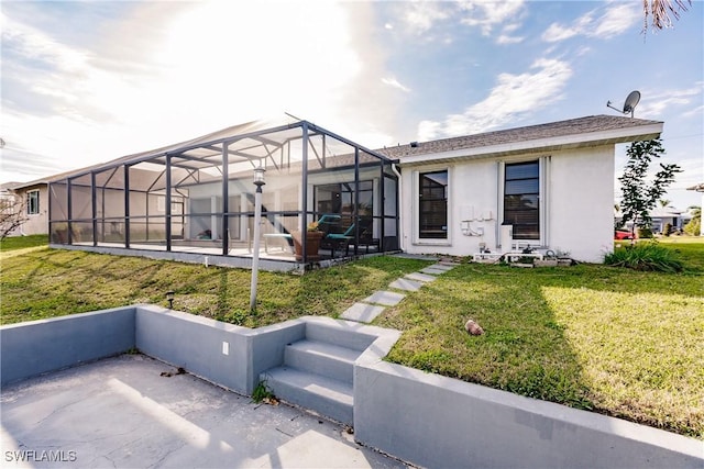 view of front of house featuring a lanai, a patio area, a front lawn, and stucco siding