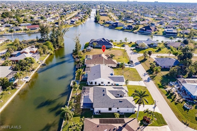 drone / aerial view featuring a water view and a residential view