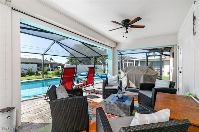 view of patio / terrace with an outdoor living space, ceiling fan, and a lanai