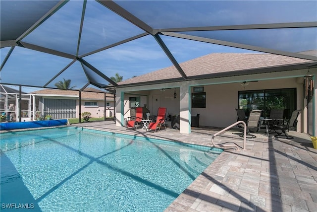 view of swimming pool featuring a patio, ceiling fan, and a lanai