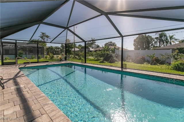 view of swimming pool featuring glass enclosure and a patio area