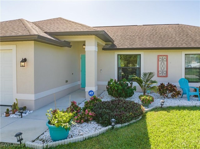 doorway to property featuring a lawn