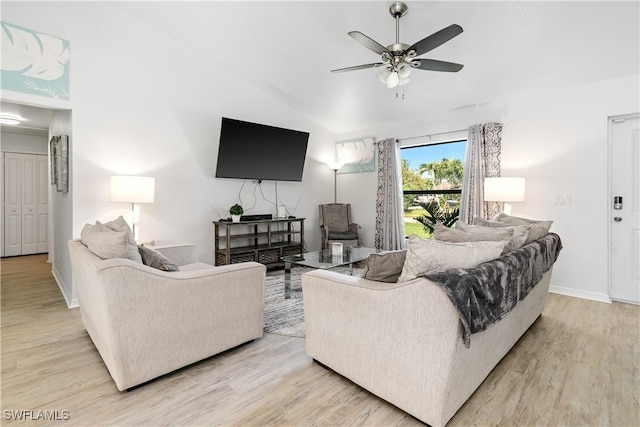 living room featuring light hardwood / wood-style floors, ceiling fan, and lofted ceiling