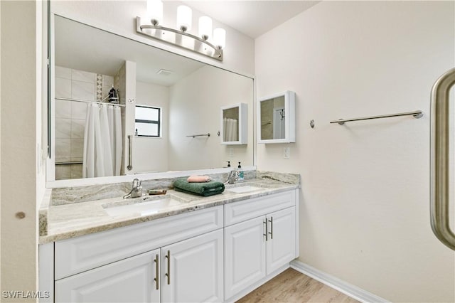 bathroom featuring a shower with shower curtain, hardwood / wood-style floors, and vanity