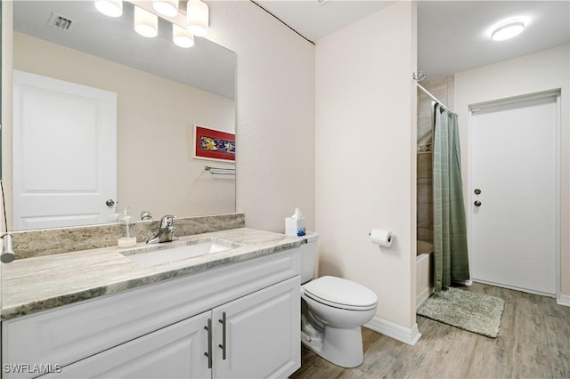 full bathroom with shower / bath combination with curtain, vanity, hardwood / wood-style flooring, and toilet