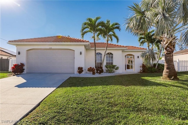 mediterranean / spanish-style house with a garage and a front lawn