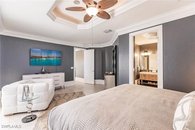 tiled bedroom with ceiling fan, a raised ceiling, crown molding, and ensuite bath