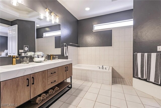 bathroom with tiled bath, tile patterned flooring, and vanity