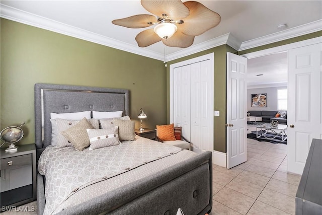 tiled bedroom with a closet, ceiling fan, and crown molding