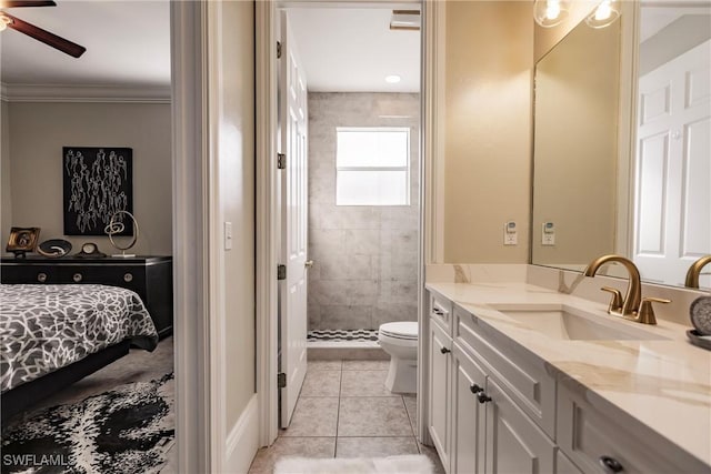 bathroom featuring vanity, tile patterned floors, toilet, ornamental molding, and tiled shower