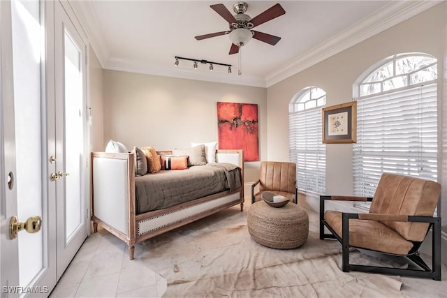 bedroom with rail lighting, ceiling fan, and crown molding