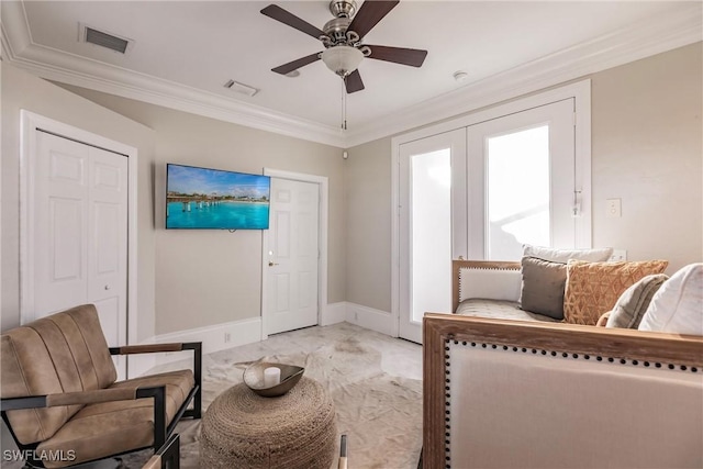 living area with ceiling fan and crown molding