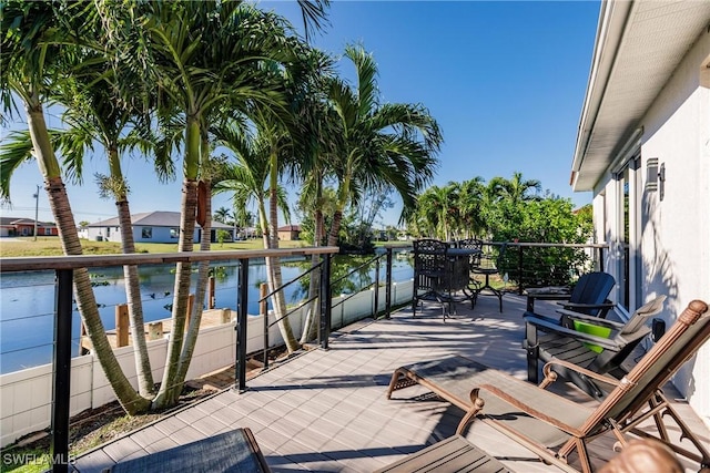 view of patio / terrace with a water view and a balcony