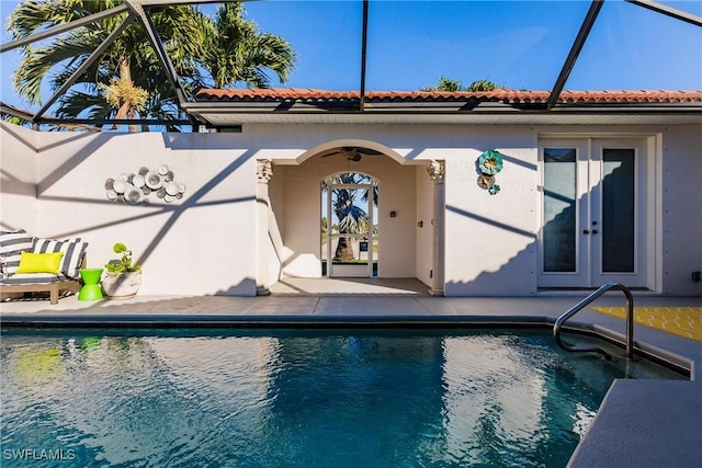 exterior space featuring glass enclosure, french doors, and a patio