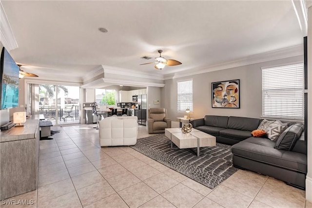 living room with ceiling fan, light tile patterned flooring, and ornamental molding