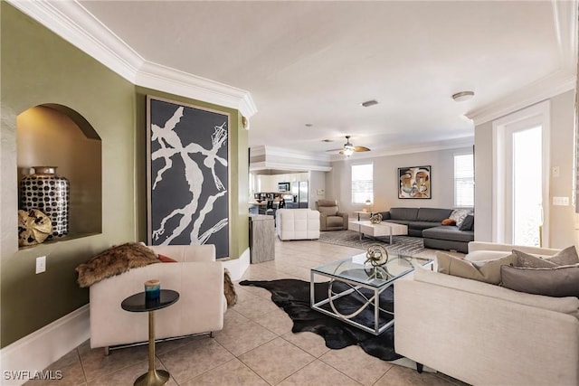 tiled living room with ceiling fan and ornamental molding