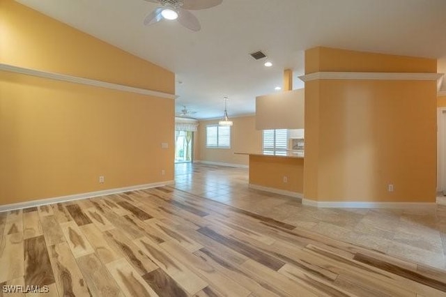 spare room featuring hardwood / wood-style floors, ceiling fan, and vaulted ceiling