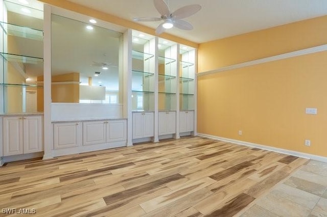 spare room featuring ceiling fan and light hardwood / wood-style flooring