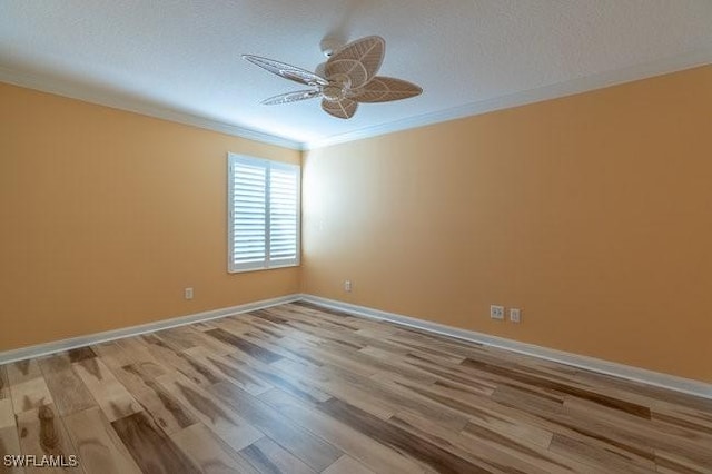 spare room with ceiling fan, ornamental molding, a textured ceiling, and light hardwood / wood-style flooring