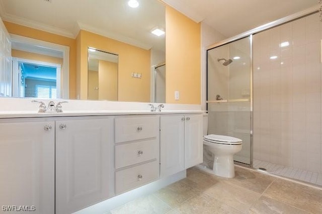 bathroom featuring vanity, toilet, a shower with shower door, and crown molding