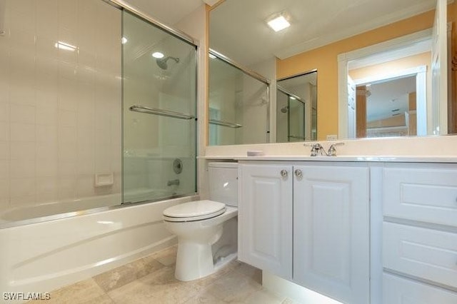 full bathroom featuring vanity, toilet, ornamental molding, and bath / shower combo with glass door