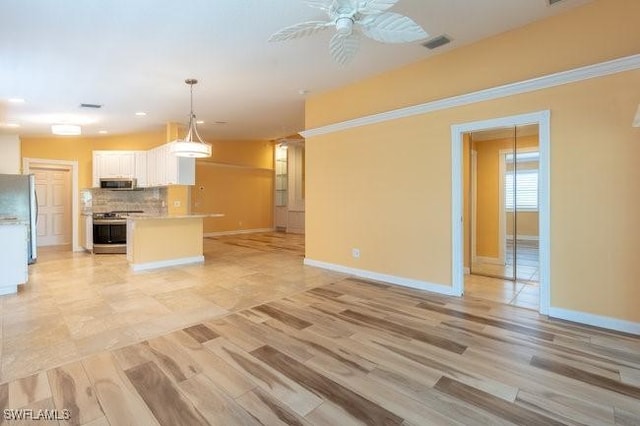 unfurnished living room with ceiling fan and light wood-type flooring