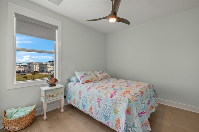 730 Matanzas Ct, Fort Myers Beach, FL 33931 - bedroom with baseboards, ceiling fan, and wood finished floors