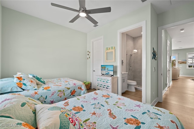 bedroom featuring visible vents, ceiling fan, connected bathroom, wood finished floors, and baseboards