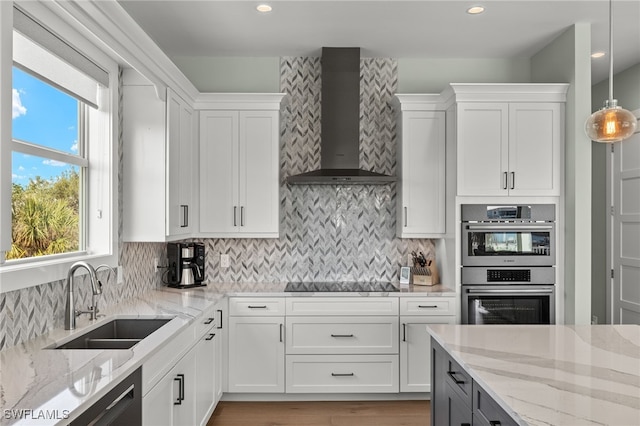 730 Matanzas Ct, Fort Myers Beach, FL 33931 - kitchen featuring wall chimney range hood, white cabinetry, black electric cooktop, double oven, and a sink