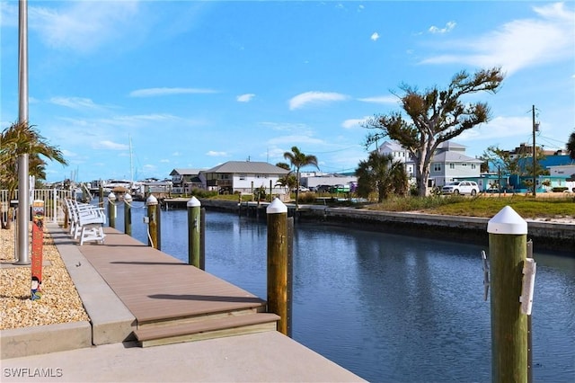 view of dock featuring a residential view and a water view